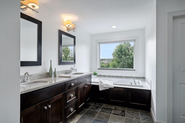 bathroom featuring a garden tub, a sink, and double vanity