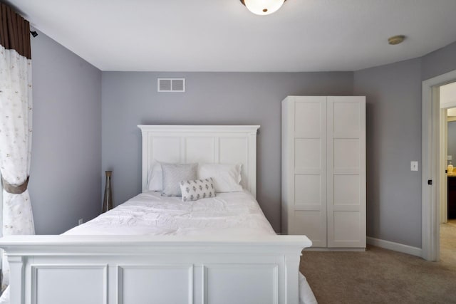 carpeted bedroom with baseboards and visible vents