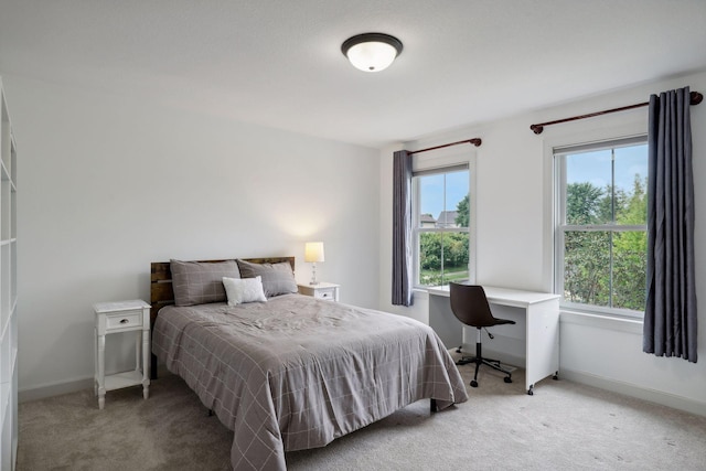 bedroom with carpet and baseboards