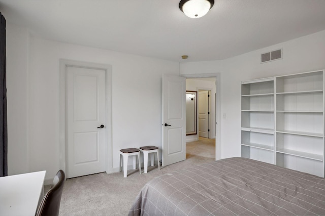 bedroom with visible vents and light colored carpet