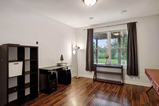 office space with a textured ceiling, dark wood-style flooring, and baseboards