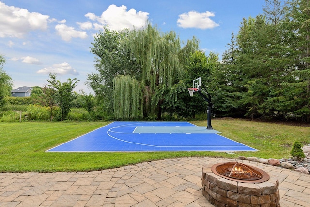 view of sport court featuring a lawn and basketball court