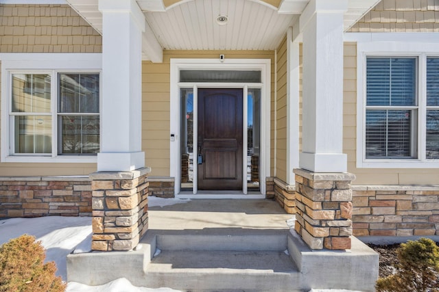 doorway to property featuring stone siding