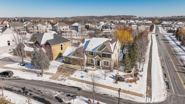 snowy aerial view with a residential view