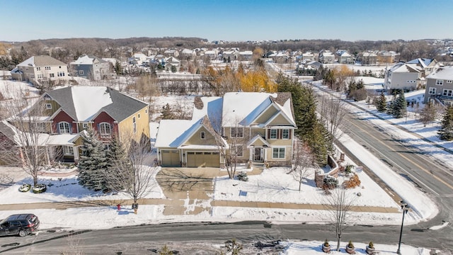 snowy aerial view with a residential view