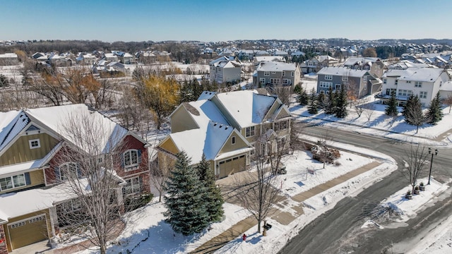 snowy aerial view with a residential view