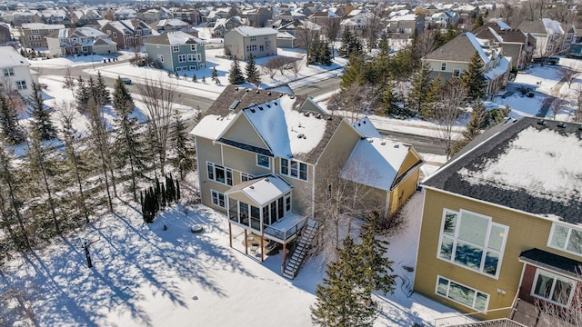 snowy aerial view featuring a residential view