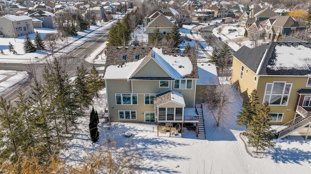 snowy aerial view with a residential view