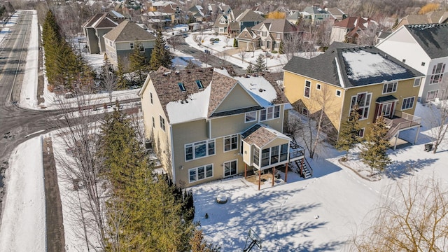 snowy aerial view with a residential view