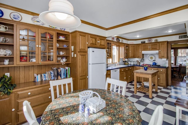 dining area featuring dark floors, visible vents, and crown molding