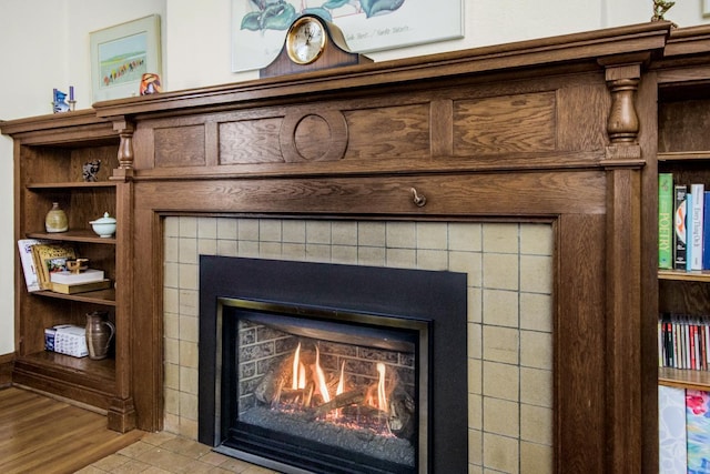 interior details featuring a tile fireplace