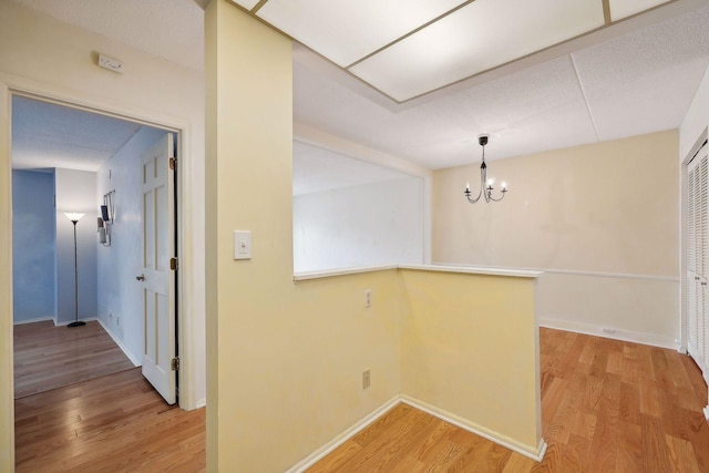 unfurnished dining area featuring hardwood / wood-style floors and an inviting chandelier