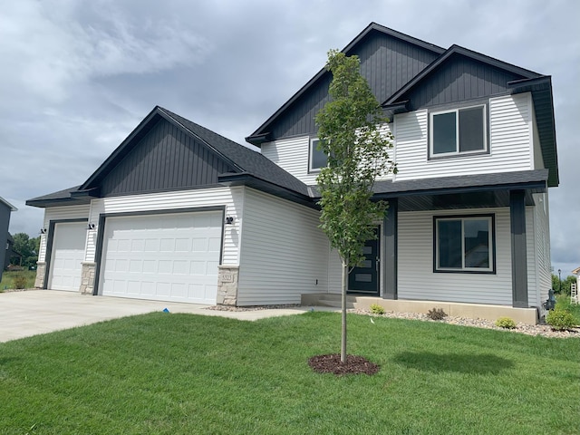 view of front facade featuring a front lawn, board and batten siding, an attached garage, and a shingled roof