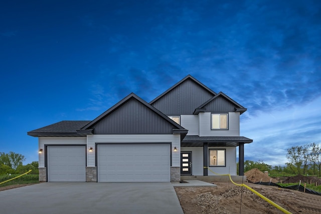 view of front of property with a garage, stone siding, driveway, and roof with shingles