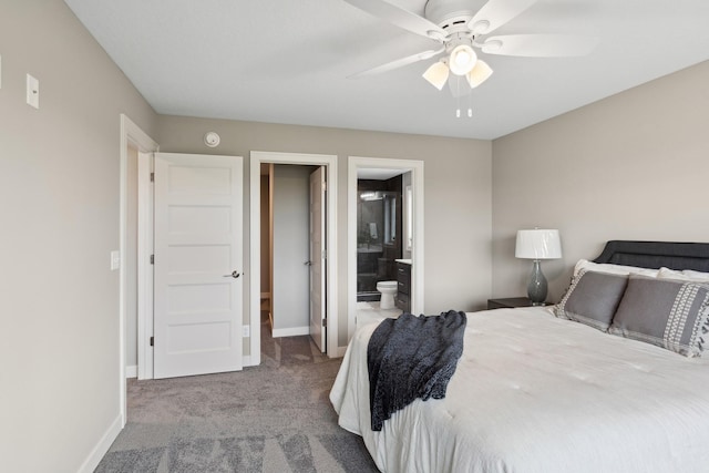 carpeted bedroom with ensuite bath, a ceiling fan, and baseboards