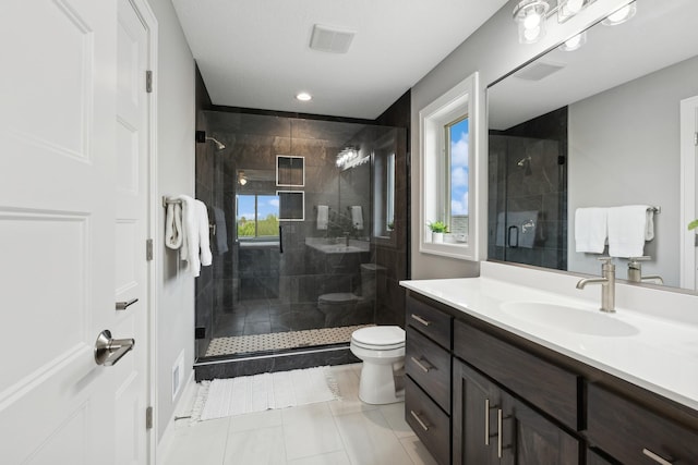 full bath with visible vents, a stall shower, vanity, and toilet