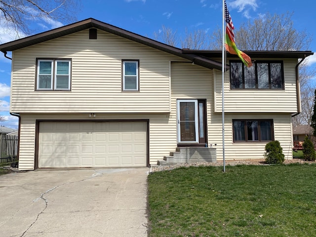 bi-level home featuring a front lawn and a garage