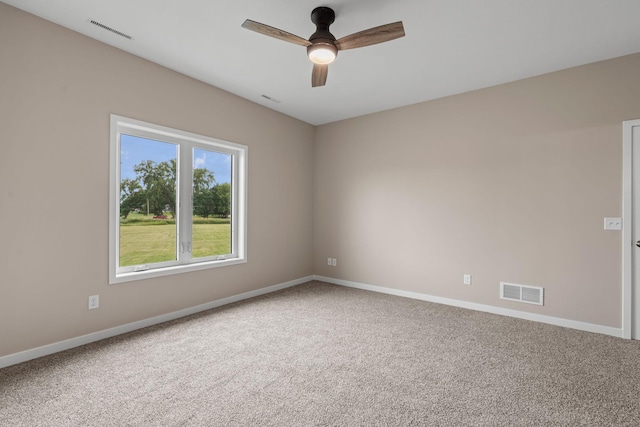 spare room featuring baseboards, visible vents, carpet floors, and ceiling fan