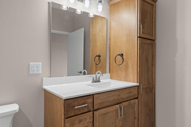 bathroom featuring toilet and vanity