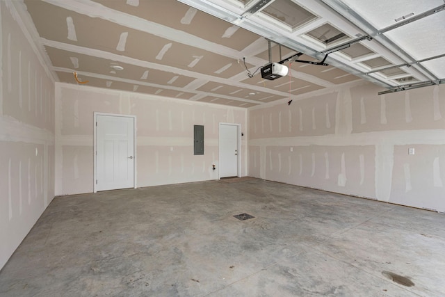 garage featuring electric panel and a garage door opener