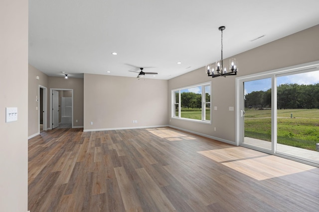 interior space featuring ceiling fan with notable chandelier, recessed lighting, wood finished floors, and baseboards