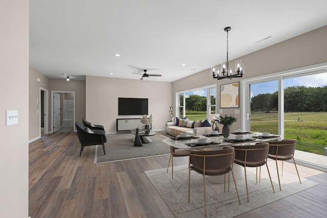 dining room featuring ceiling fan with notable chandelier, recessed lighting, wood finished floors, and baseboards