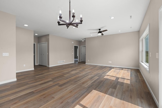 empty room with wood finished floors, visible vents, baseboards, recessed lighting, and ceiling fan with notable chandelier