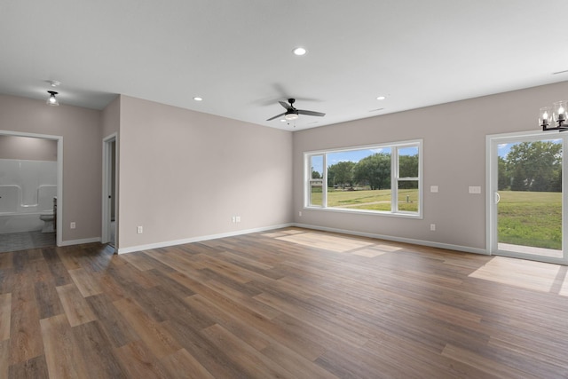 unfurnished living room with recessed lighting, baseboards, and wood finished floors