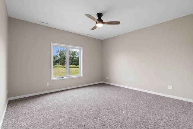 unfurnished room featuring visible vents, baseboards, carpet, and a ceiling fan