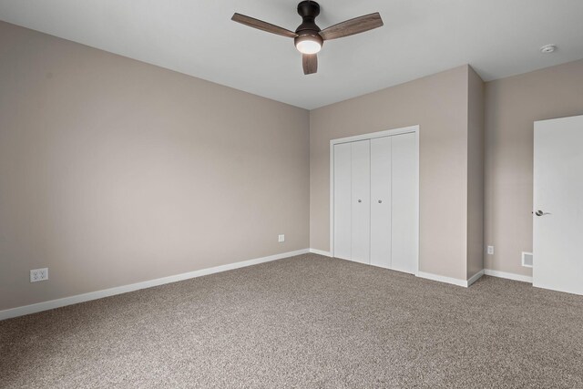 unfurnished bedroom with a closet, carpet flooring, visible vents, and baseboards