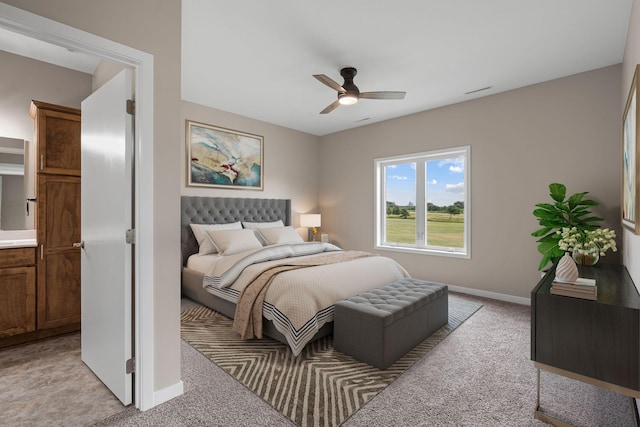 bedroom featuring a ceiling fan, light colored carpet, and baseboards