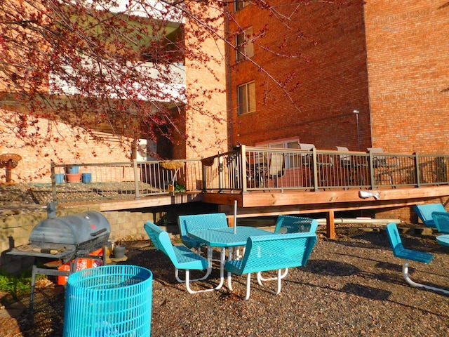 view of patio with a grill, a wooden deck, and central AC