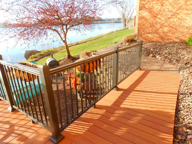 wooden terrace featuring a water view