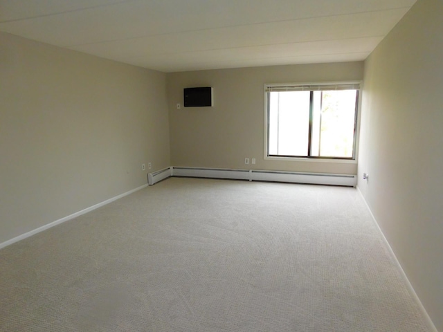 unfurnished room featuring light colored carpet and a baseboard radiator