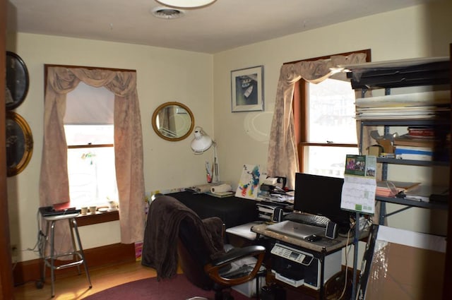 office area with a healthy amount of sunlight and hardwood / wood-style floors