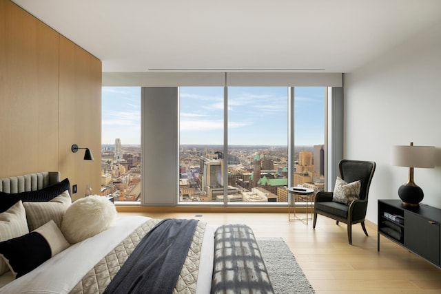 bedroom with multiple windows and light wood-type flooring