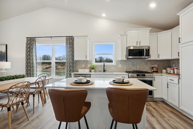 kitchen featuring white cabinets, appliances with stainless steel finishes, and light hardwood / wood-style floors