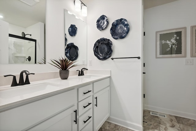 bathroom with a shower with door and vanity