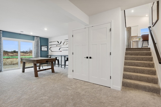 recreation room featuring light colored carpet