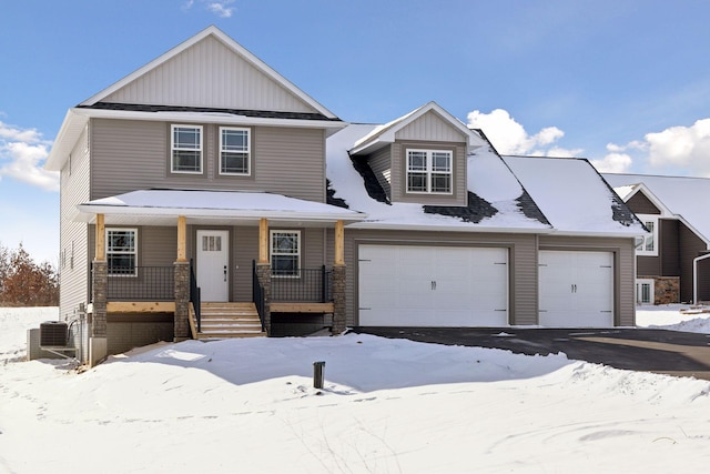 view of front of property with cooling unit, a garage, and a porch