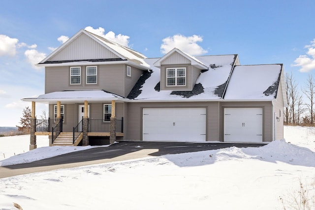 view of front of home featuring a porch and a garage