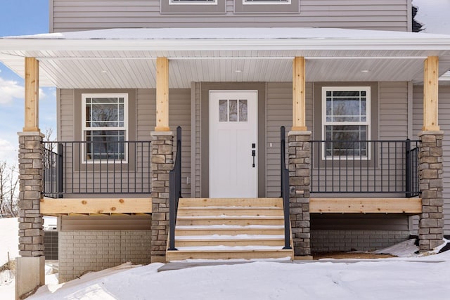 view of snow covered property entrance