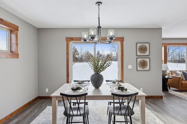 dining room featuring a notable chandelier and dark hardwood / wood-style floors