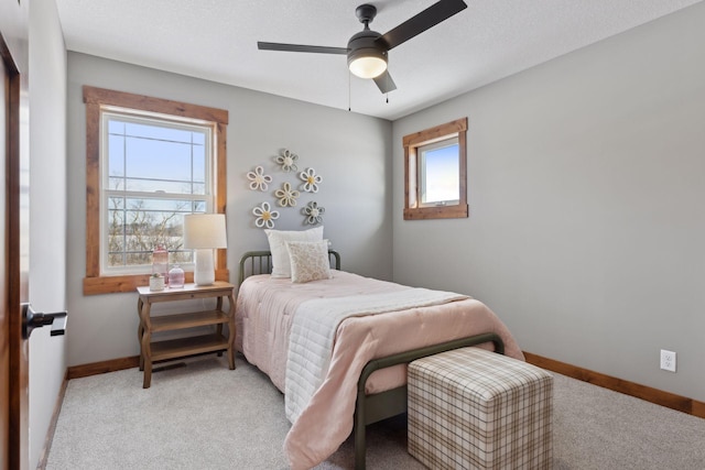 carpeted bedroom with a textured ceiling and ceiling fan