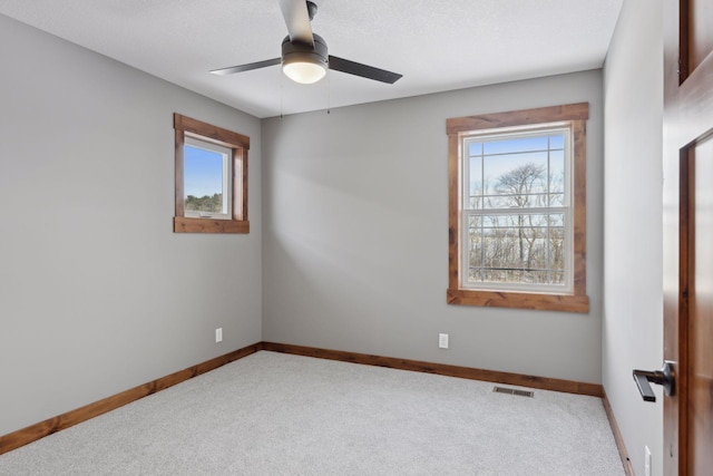 unfurnished room featuring carpet floors, a textured ceiling, and ceiling fan