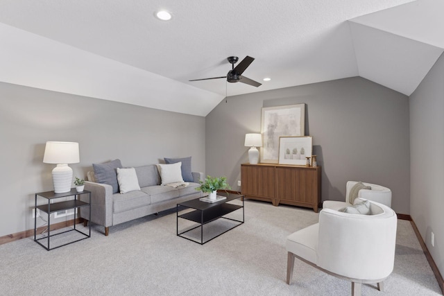 carpeted living room with vaulted ceiling and ceiling fan