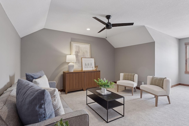 carpeted living room with vaulted ceiling and ceiling fan