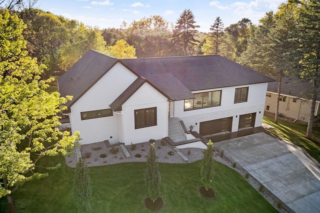 view of front of home with a front yard and a garage