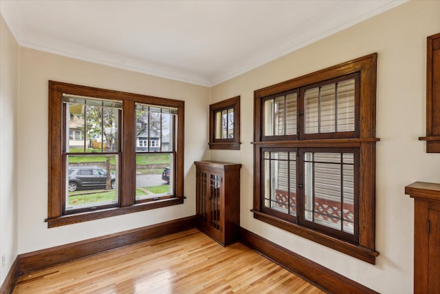 unfurnished room featuring crown molding and light hardwood / wood-style floors