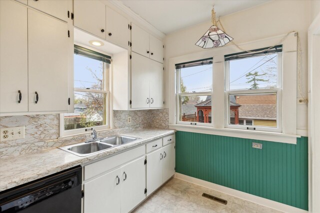 kitchen with dishwasher, white cabinets, and sink